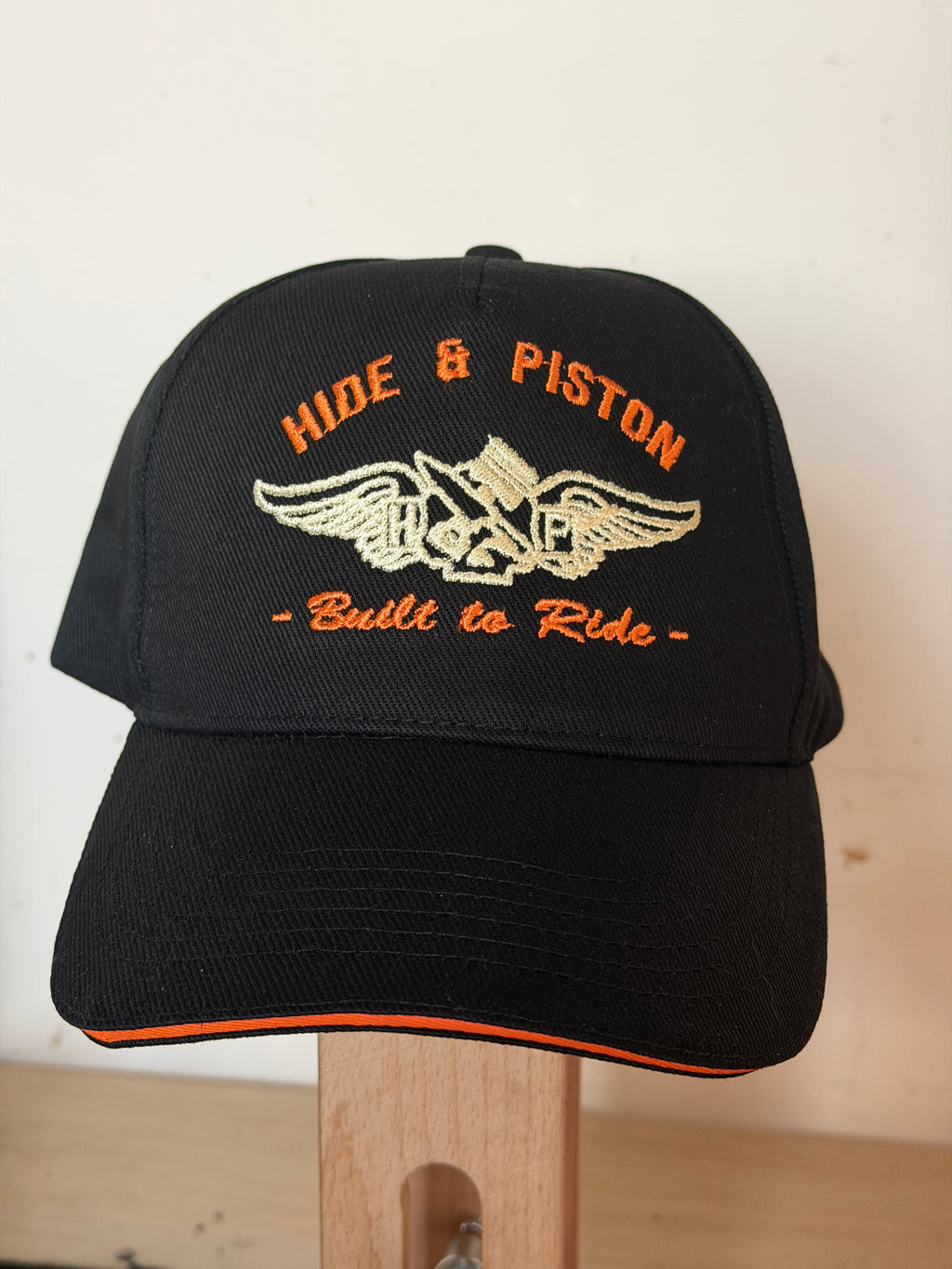 Hide & Piston black and orange embroidered biker cap